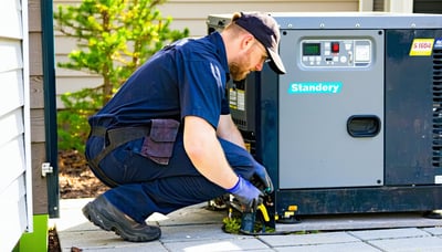 Technician servicing a standby generator